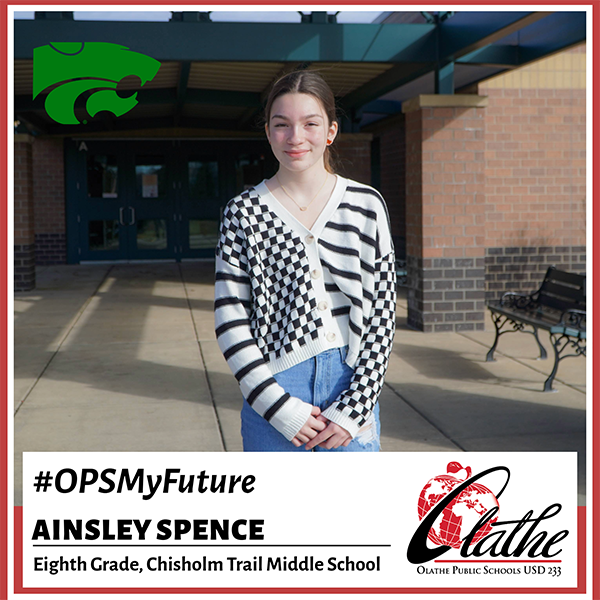 Ainsley stands in front of her school