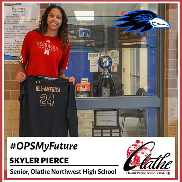 Skyler holding All-America jersey in front of school trophy case