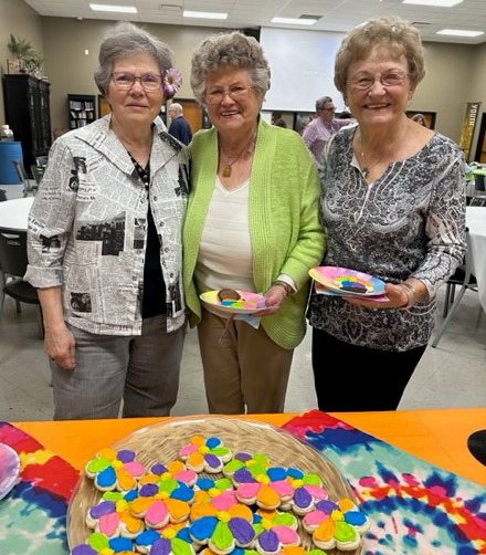 three women with plates of cookies