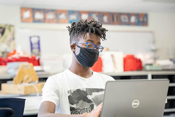 photo of high school student at laptop