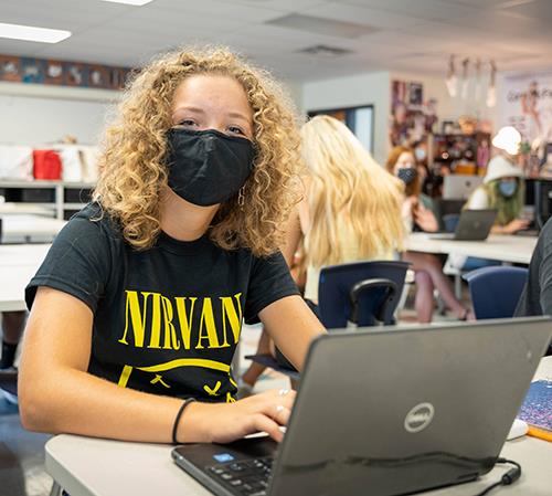 photo of high school student working on laptop