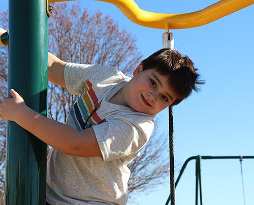 boy on playground equipment