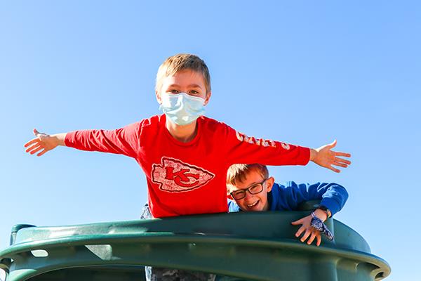 boys playing on playground equipment