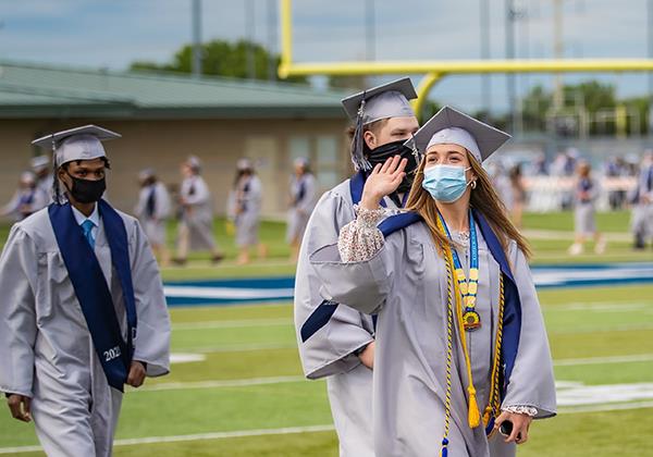 students walk in graduation ceremony