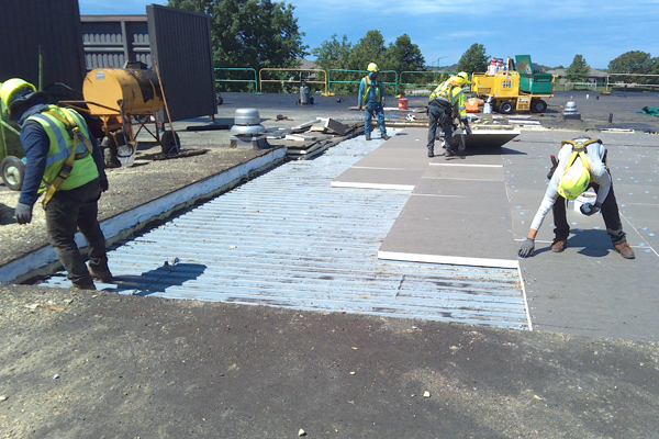 roofers work on elementary school