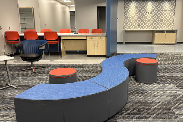 comfy seating in blue and orange colors adorns the activity area