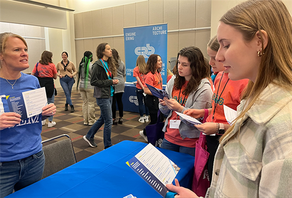 girls listen to adult talk about careers in engineering