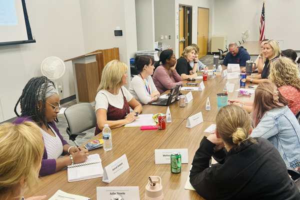 people talking around a conference table