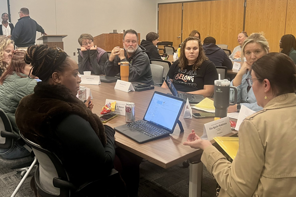 people talking around a conference table