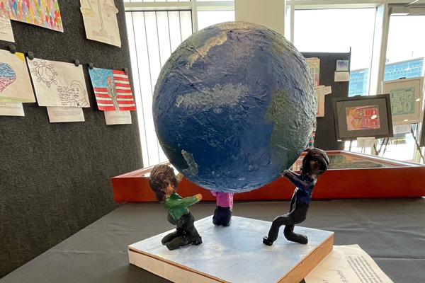 a 3D entry depicting people supporting a globe